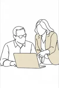 Two colleagues looking at a laptop screen together